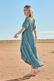 Model Tegan wearing size 10 of the Chasing Butterflies Cotton Dress in colour Sage (Green), from the front, showing the whole outfit