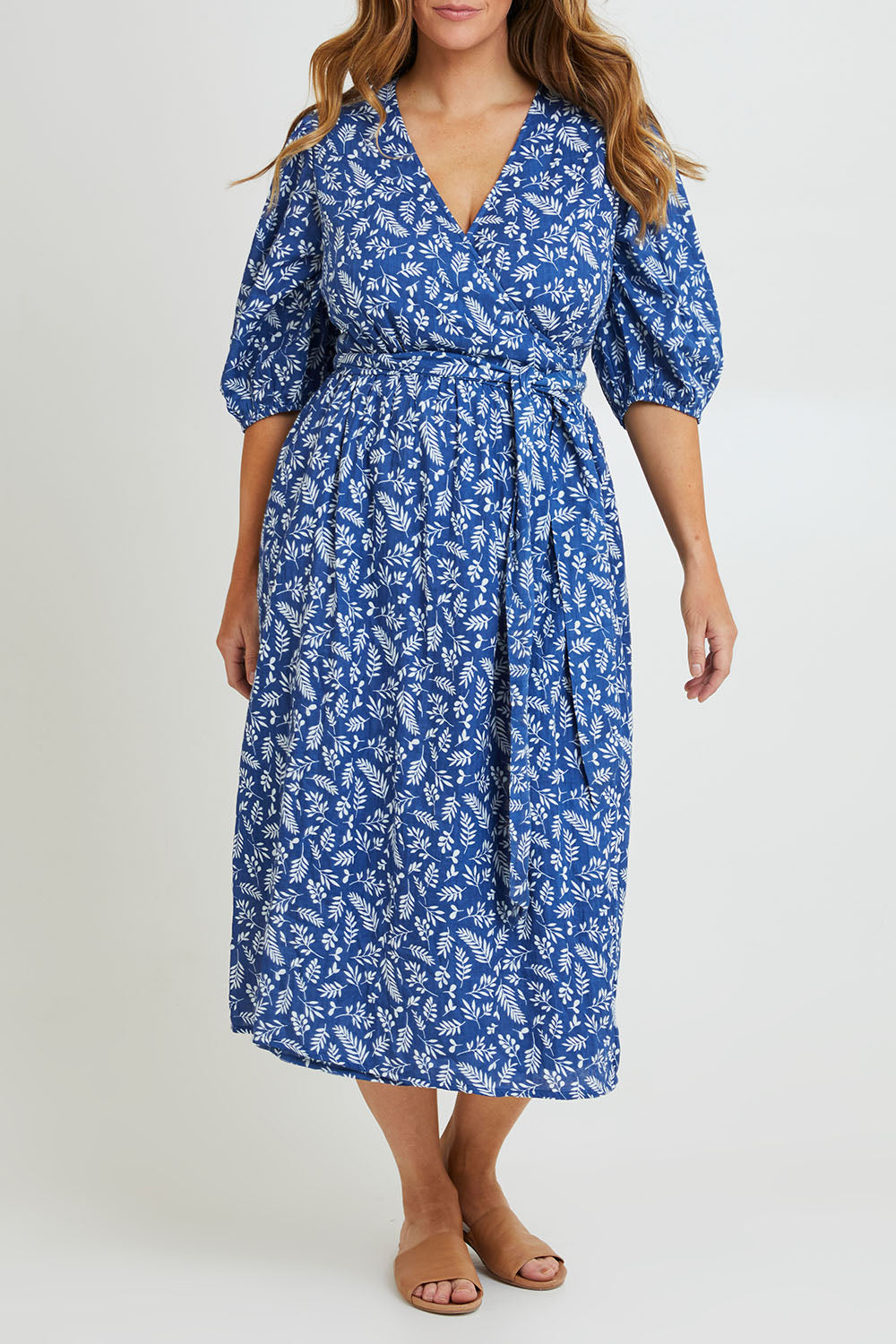 Model Laura wearing size 14 of the In The Morning Light Wrap Dress in colour Blueleaf (Blue), from the front, cropped image