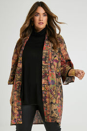 Model Laura wearing size 14 of the You Colour My World Long Kimono in colour Patchprint (Black), from the front, cropped image