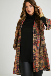 Model Laura wearing size 14 of the You Colour My World Long Kimono in colour Patchprint (Black), from the front, cropped image