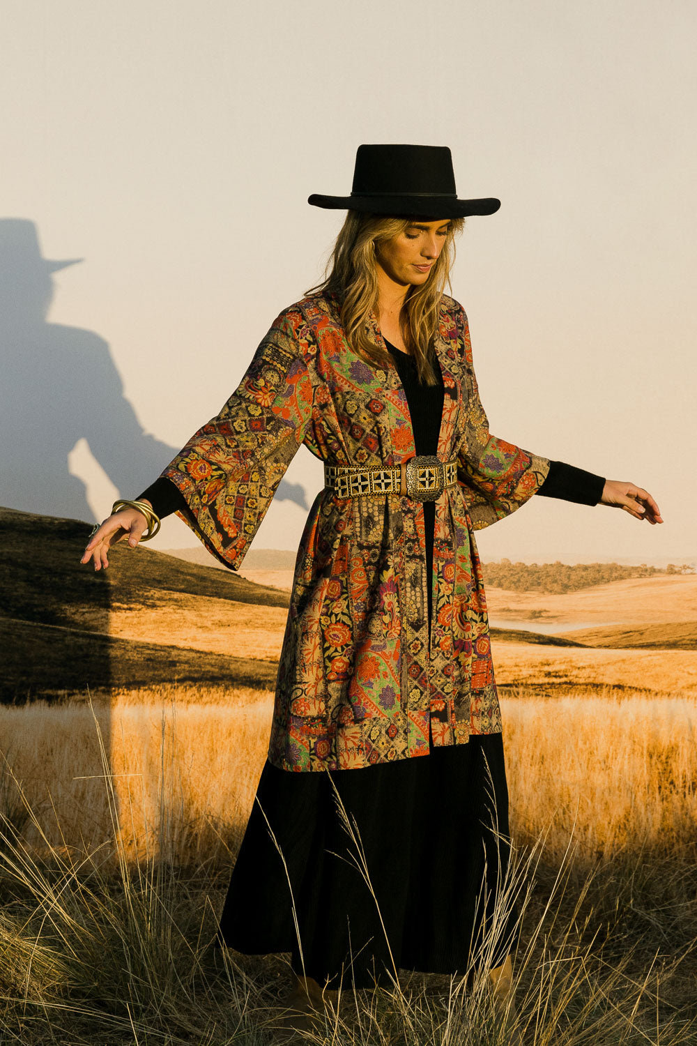 Model Tegan wearing size 10 of the You Colour My World Long Kimono in colour Patchprint (Black), from the front, showing the whole outfit
