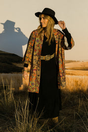 Model Tegan wearing size 10 of the You Colour My World Long Kimono in colour Patchprint (Black), from the front, showing the whole outfit