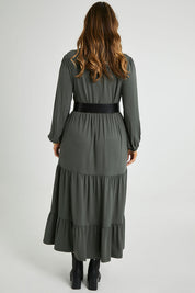 Model Laura wearing size 14 of the Tiered Delight Bamboo Dress in colour Combat (Green), from the back