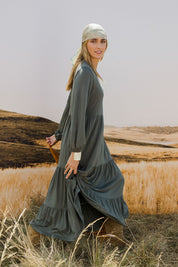 Model Tegan wearing size 10 of the Tiered Delight Bamboo Dress in colour Combat (Green), from the front, showing the whole outfit