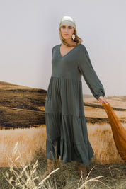 Model Tegan wearing size 10 of the Tiered Delight Bamboo Dress in colour Combat (Green), from the front, showing the whole outfit