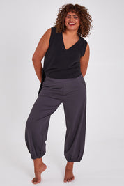 Model Anucia wearing size 14 of the Keeping It Cool Boyfriend Pants in colour Castle (Grey), from the front, showing the whole outfit