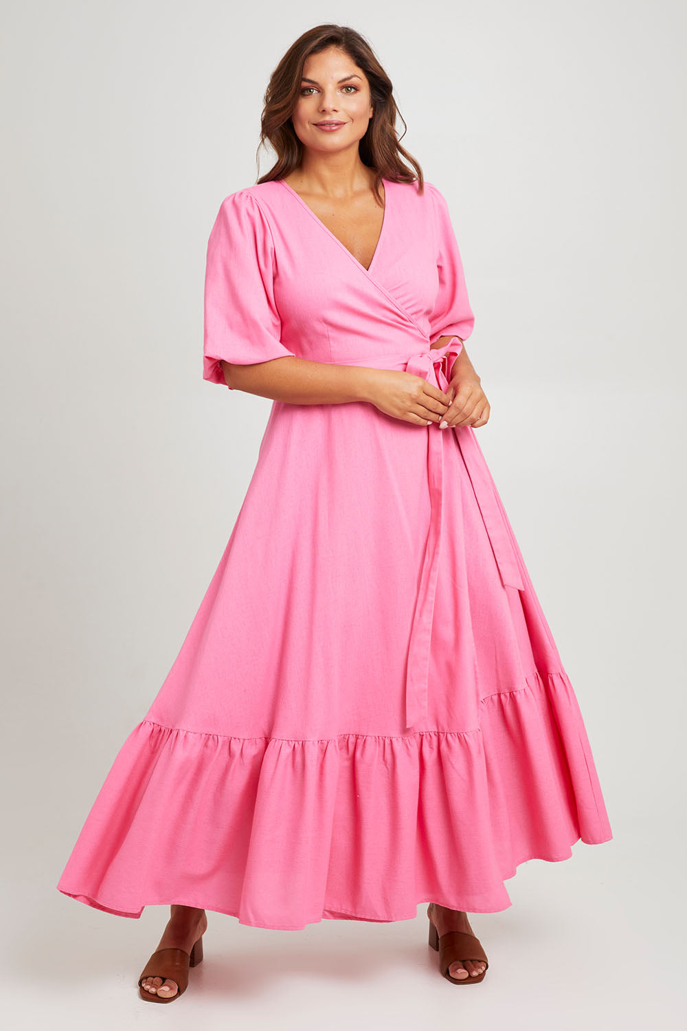 Model Monique wearing size 14 of the La Dolce Vita Puff Sleeve Dress in colour Bubblegum (Pink), from the front, showing the whole outfit