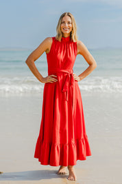 Model Riina wearing size 10 of the La Dolce Vita Back Wrap Maxi in colour Red (Red), from the front, showing the whole outfit