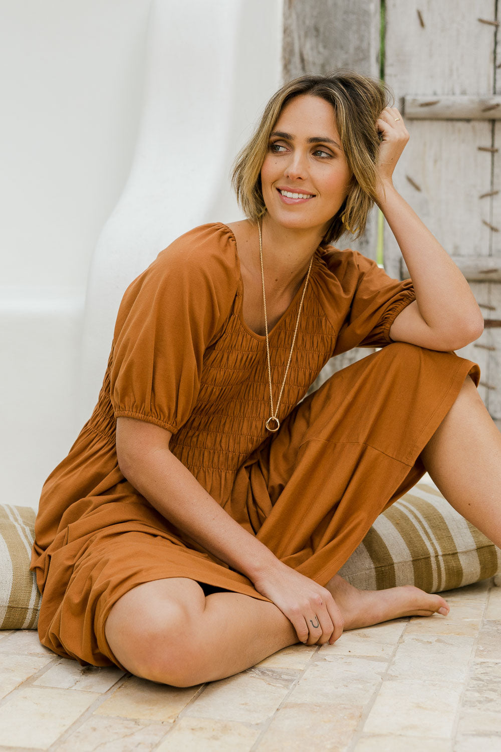Model Tegan wearing size 10 of the Casual Friday Dress in colour Rust, from the front, showing the whole outfit