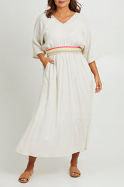 Model Monique wearing size 14 of the Daydream Cotton Kaftan Dress in colour Wheat, from the front, cropped image