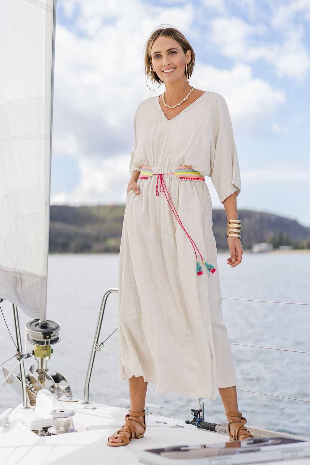 Model Tegan wearing size 10 of the Daydream Cotton Kaftan Dress in colour Wheat, from the front, showing the whole outfit