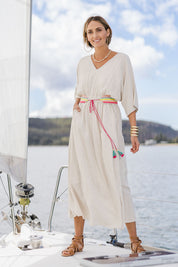 Model Tegan wearing size 10 of the Daydream Cotton Kaftan Dress in colour Wheat, from the front, showing the whole outfit