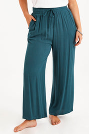 Model Monique wearing size 14 of the Brunch Lunch And Dinner Pants in colour Sage (Green), from the front, cropped image