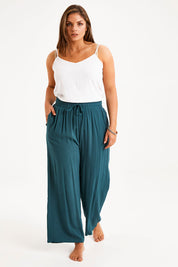 Model Monique wearing size 14 of the Brunch Lunch And Dinner Pants in colour Sage (Green), from the front, showing the whole outfit