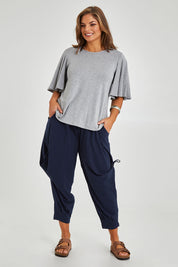 Model Monique wearing size 14 of the Flutter By Tee in colour Lightgrey (Grey), from the front, showing the whole outfit