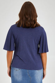 Model Monique wearing size 14 of the Flutter By Tee in colour Marldenim (Blue), from the back