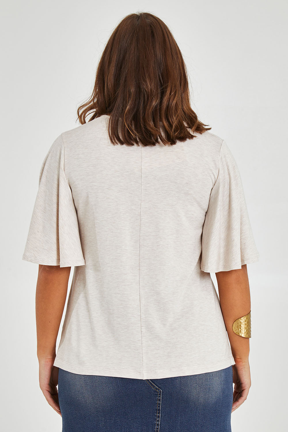 Model Monique wearing size 14 of the Flutter By Tee in colour Natural, from the back