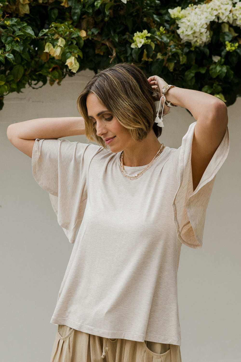 Model Tegan wearing size 8 of the Flutter By Tee in colour Natural, from the front, cropped image
