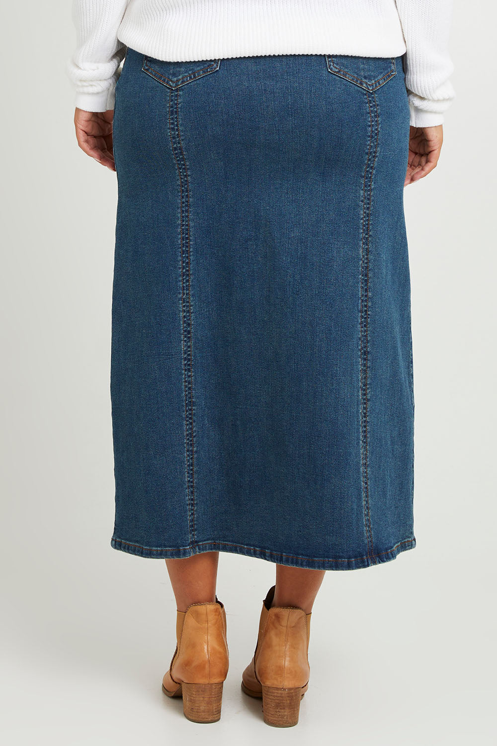 Model Monique wearing size 14 of the Easy As Pull On Panel Skirt in colour Darkdenim (Blue), from the back