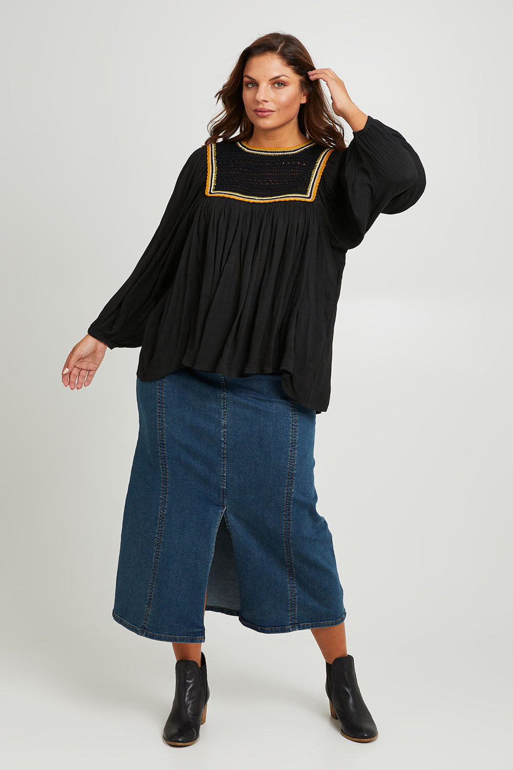 Model Monique wearing size 14 of the Ebb And Flow Crochet Detail Top in colour Black (Black), from the front, showing the whole outfit