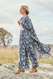 Model Tegan wearing size 10 of the Swept Away By You Duster Blouse in colour Bluefleur (Blue), from the front, showing the whole outfit