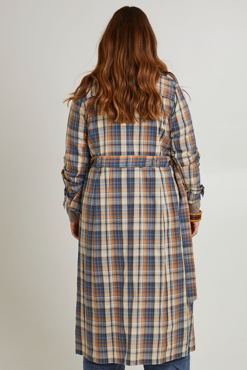 Model Laura wearing size 14 of the Check Me Out Trench Coat in colour Bluecheck (Blue), from the back