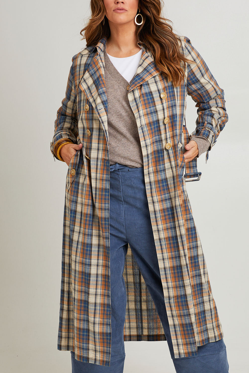 Model Laura wearing size 14 of the Check Me Out Trench Coat in colour Bluecheck (Blue), from the front, cropped image