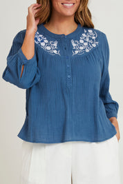 Model Laura wearing size 14 of the First Light Cotton Blouse in colour Dutchblue (Blue), from the front, cropped image