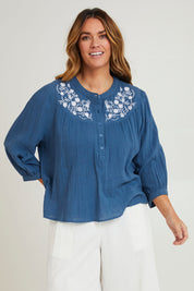 Model Laura wearing size 14 of the First Light Cotton Blouse in colour Dutchblue (Blue), from the front, cropped image