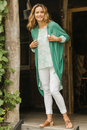 Model Ilona wearing size 10 of the Falling For You Cardi in colour Myrtle (Green), from the front, showing the whole outfit