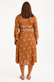 Model Monique wearing size 14 of the Dancing With Birds Midi Dress in colour Clay, from the back
