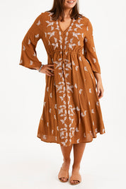 Model Monique wearing size 14 of the Dancing With Birds Midi Dress in colour Clay, from the front, cropped image