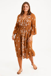 Model Monique wearing size 14 of the Dancing With Birds Midi Dress in colour Clay, from the front, showing the whole outfit