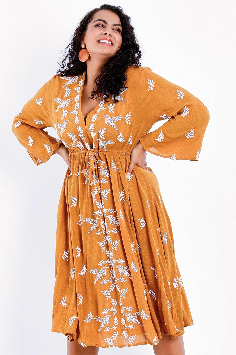 Model Sasha-Lee wearing size 16 of the Dancing With Birds Midi Dress in colour Clay, from the front, cropped image