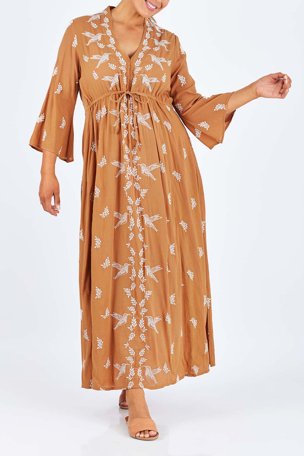 Model Palatina wearing size 14 of the Dancing With Birds Dress in colour Golden, from the front, cropped image