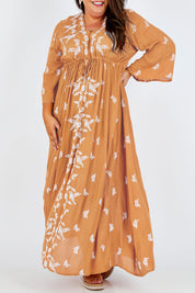 Model Stacey wearing size 16 of the Dancing With Birds Dress in colour Golden, from the front, cropped image