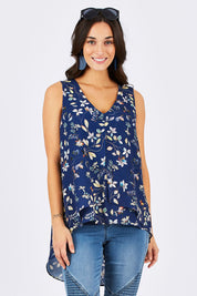 Model Georgia wearing size 10 of the Sugar Snaps Layer Tank in colour NavyLeaf (Blue), from the front, cropped image