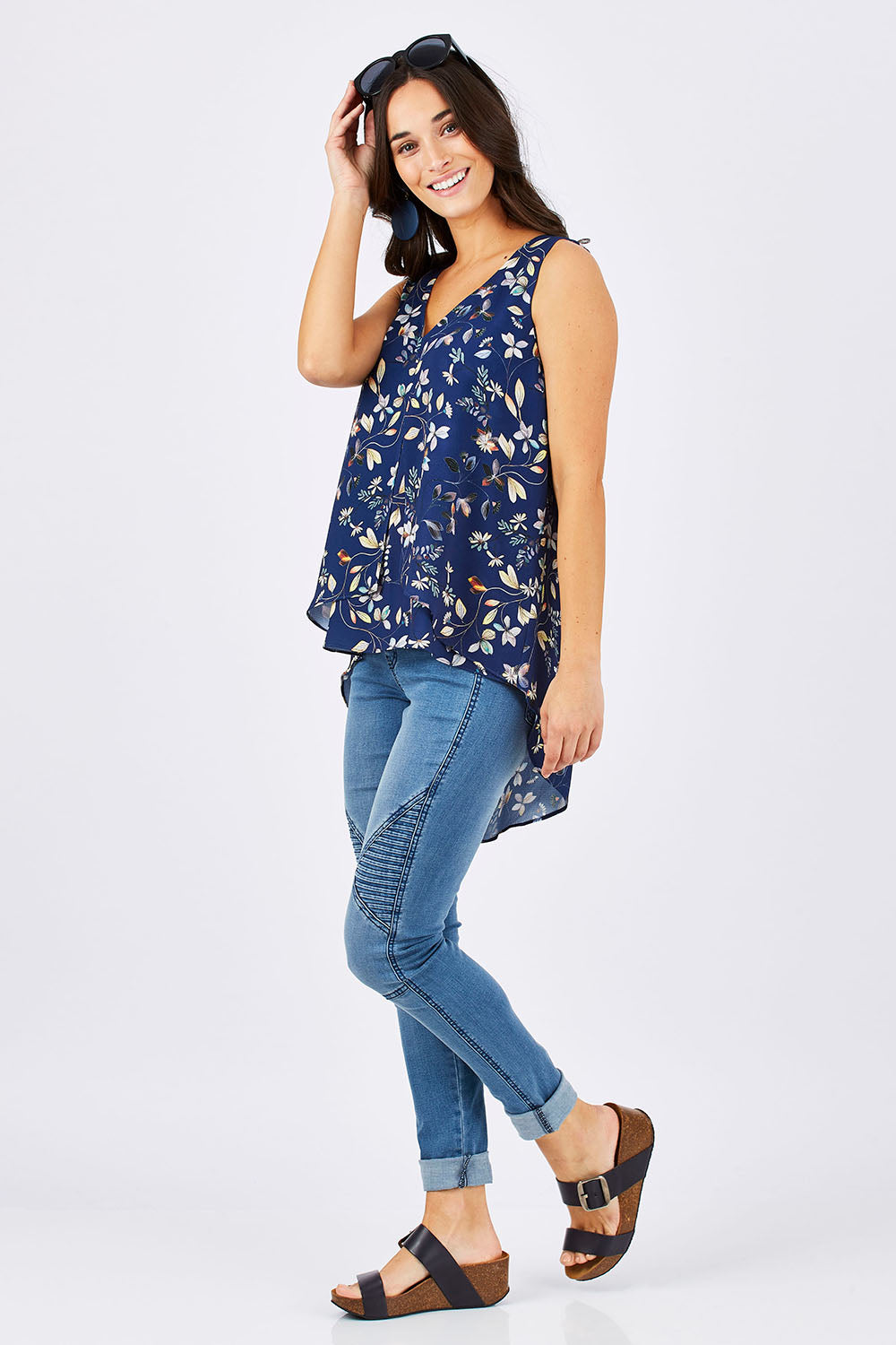 Model Georgia wearing size 10 of the Sugar Snaps Layer Tank in colour NavyLeaf (Blue), from the front, showing the whole outfit
