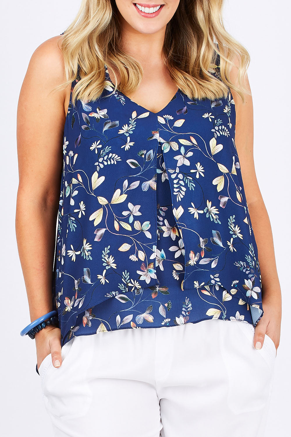 Model Jess wearing size 14 of the Sugar Snaps Layer Tank in colour NavyLeaf (Blue), from the front, cropped image