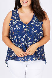 Model Mae wearing size 18 of the Sugar Snaps Layer Tank in colour NavyLeaf (Blue), from the front, cropped image
