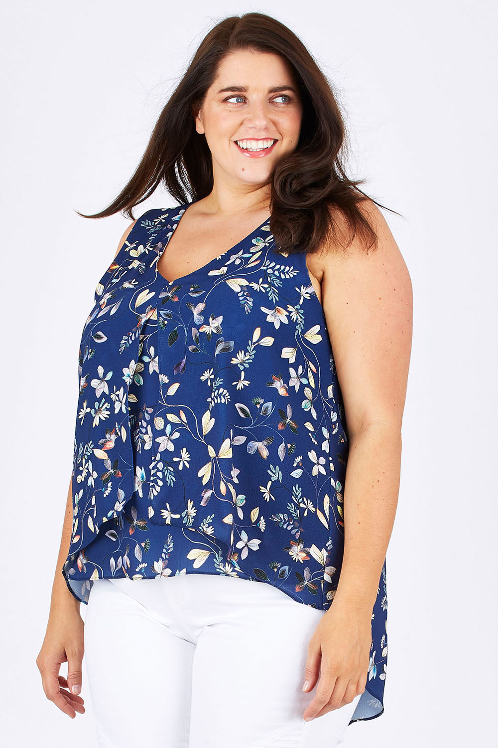 Model Mae wearing size 18 of the Sugar Snaps Layer Tank in colour NavyLeaf (Blue), from the front, cropped image