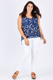 Model Mae wearing size 18 of the Sugar Snaps Layer Tank in colour NavyLeaf (Blue), from the front, showing the whole outfit