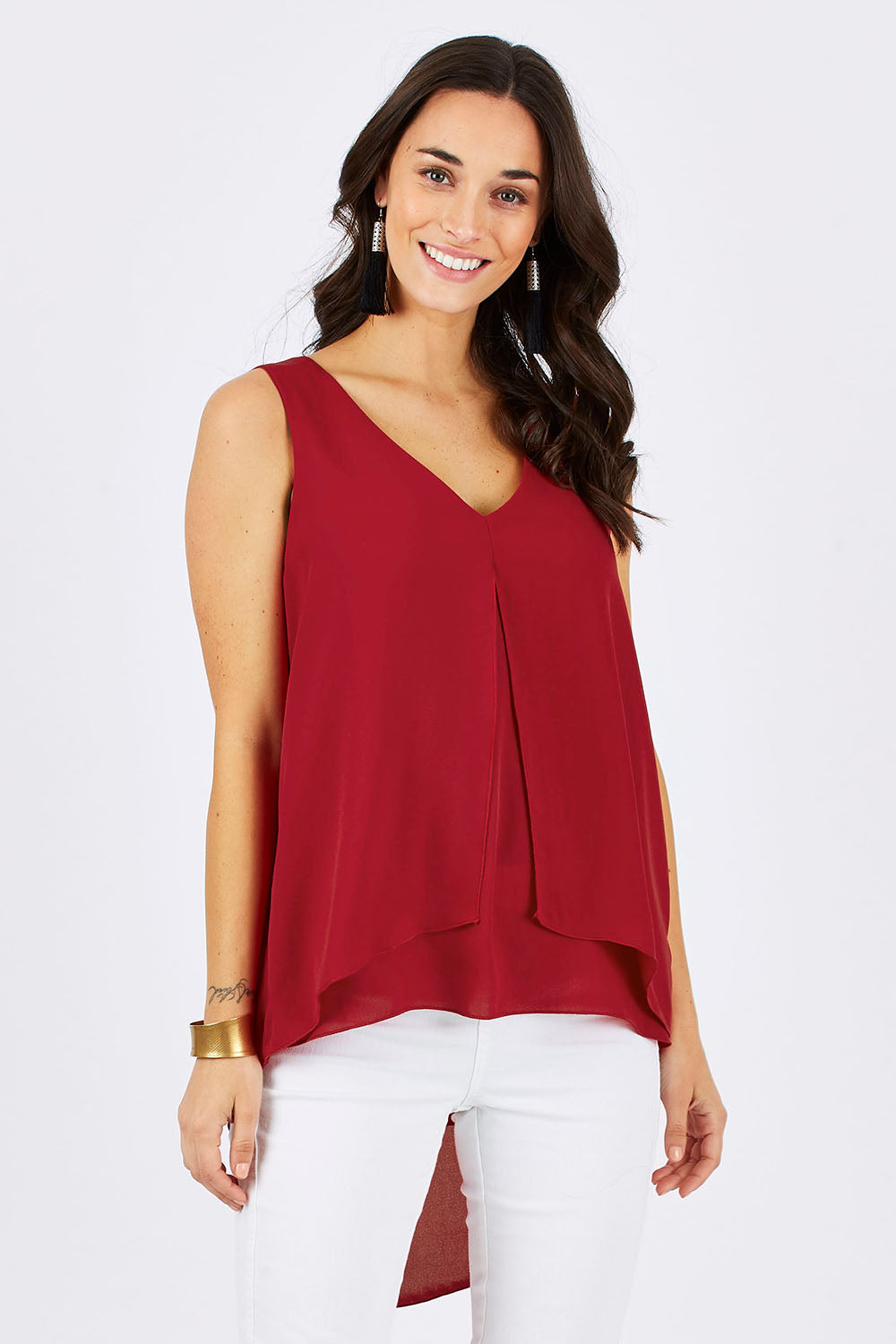 Model Georgia wearing size 10 of the Sugar Snaps Layers Tank in colour Red (Red), from the front, cropped image