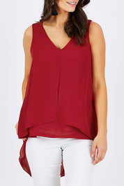 Model Georgia wearing size 10 of the Sugar Snaps Layers Tank in colour Red (Red), from the front, cropped image