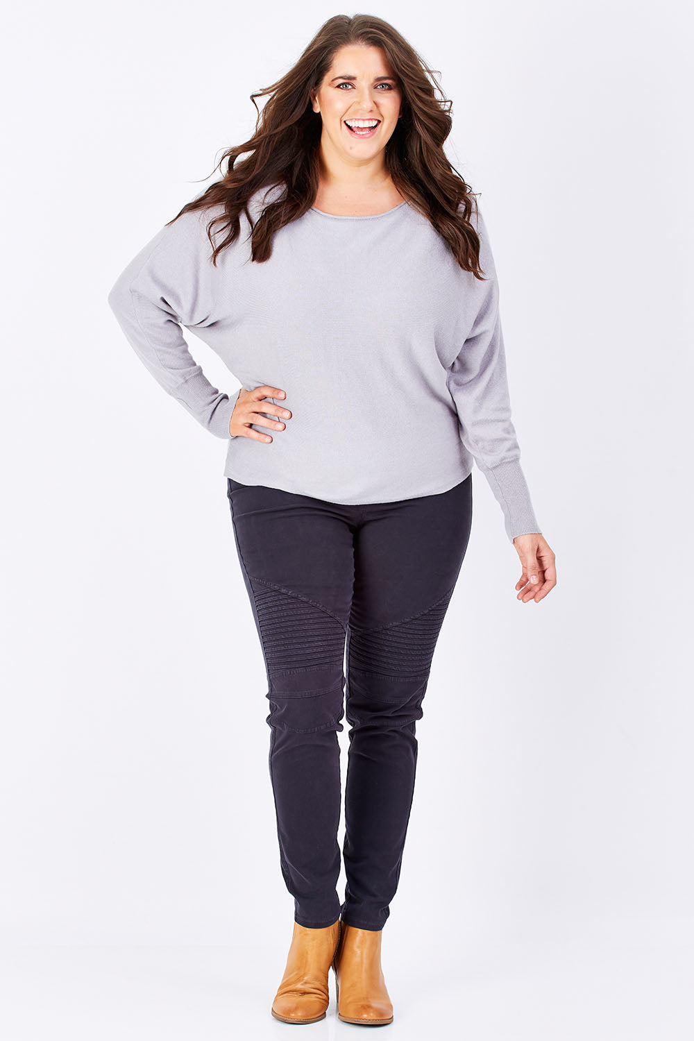 Model Mae wearing size 16 of the Wild Tribe Stitched Jeggings in colour Indigo (Blue), from the front, showing the whole outfit