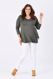 Model Mae wearing size 18 of the Long Sleeve Softly Swinging Bamboo Tee in colour Combat (Black), from the front, showing the whole outfit