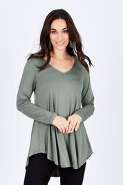 Model Georgia wearing size 10 of the Long Sleeve Softly Swinging Bamboo Tee in colour Fern (Green), from the front, cropped image