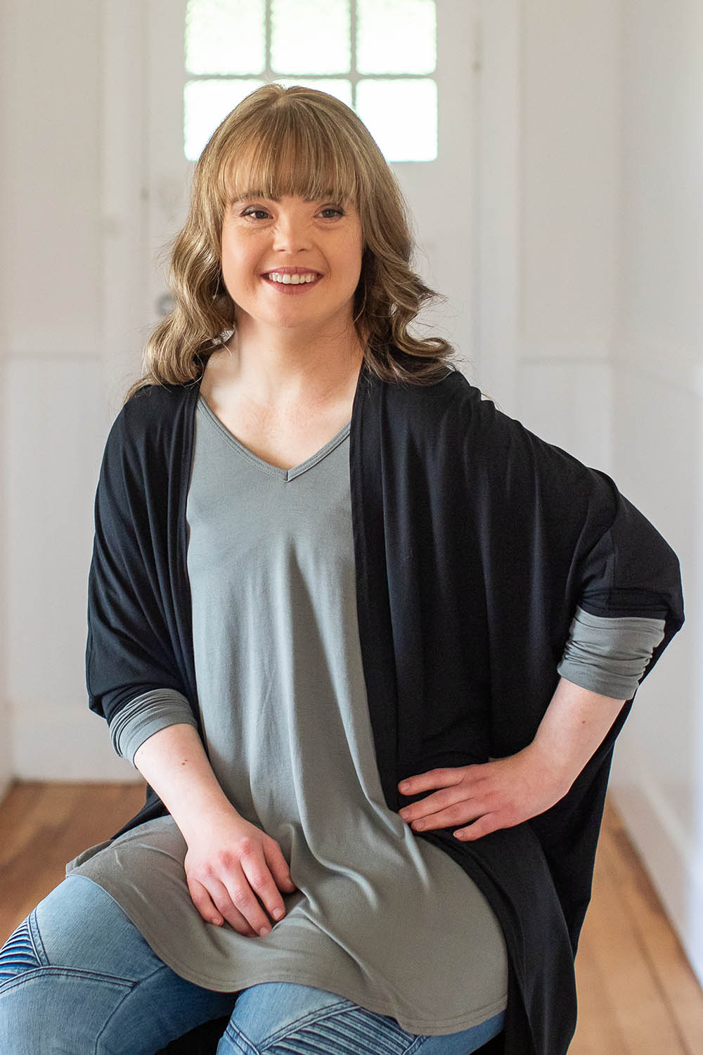 Model Katie wearing size 10 of the Long Sleeve Softly Swinging Bamboo Tee in colour Fern (Green), from the front, showing the whole outfit