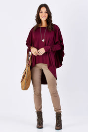 Model Georgia wearing size 10 of the Cape Horn Tunic in colour Scarlet (Purple), from the front, showing the whole outfit