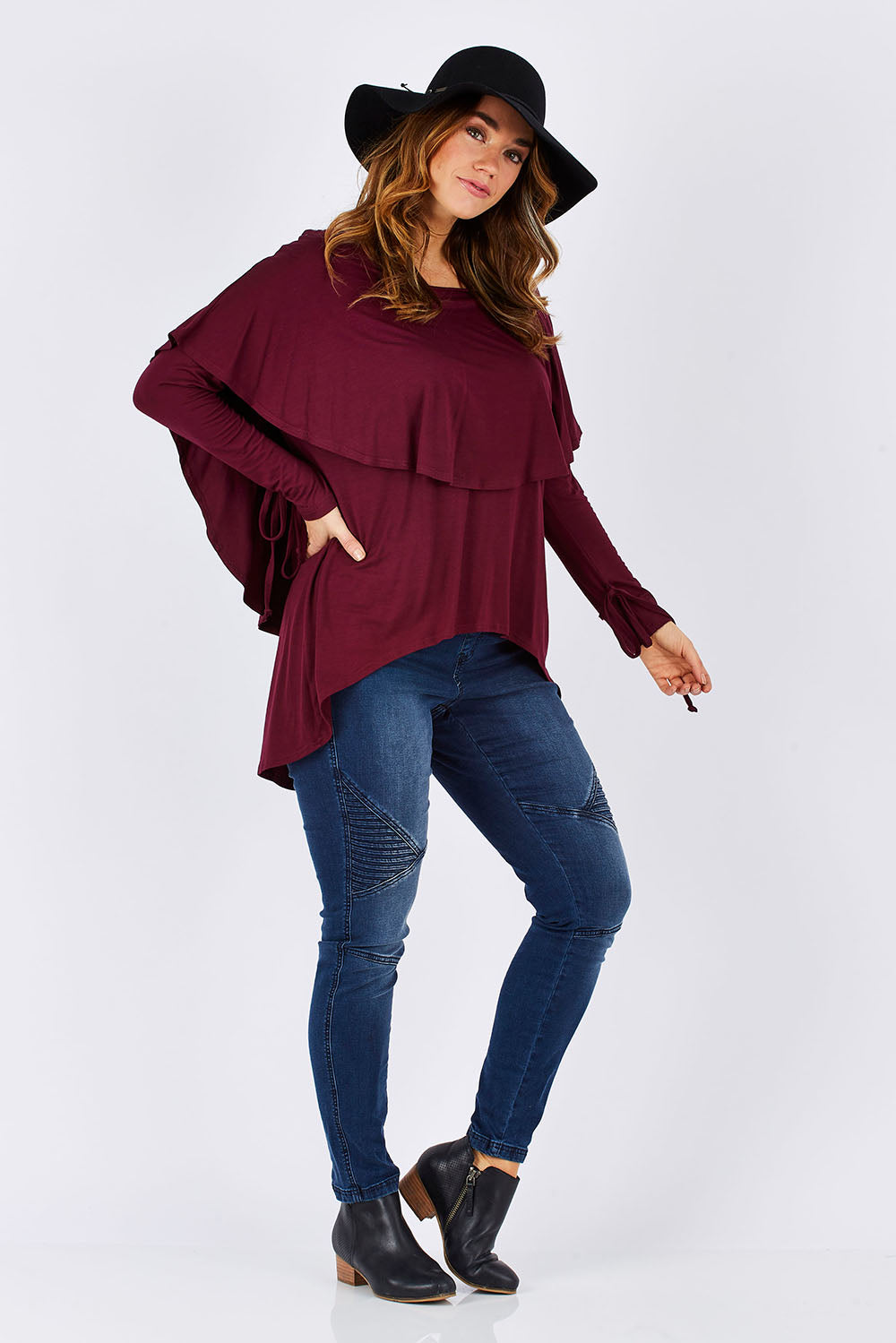 Model Laura wearing size 12 of the Cape Horn Tunic in colour Scarlet (Purple), from the front, showing the whole outfit